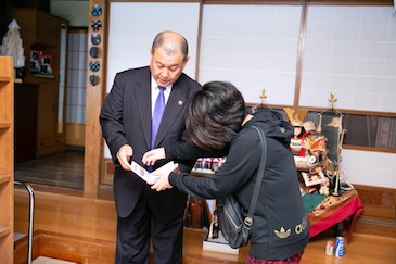 She asked about the origin of the red ink stamp and got more information about various things through her conversation.